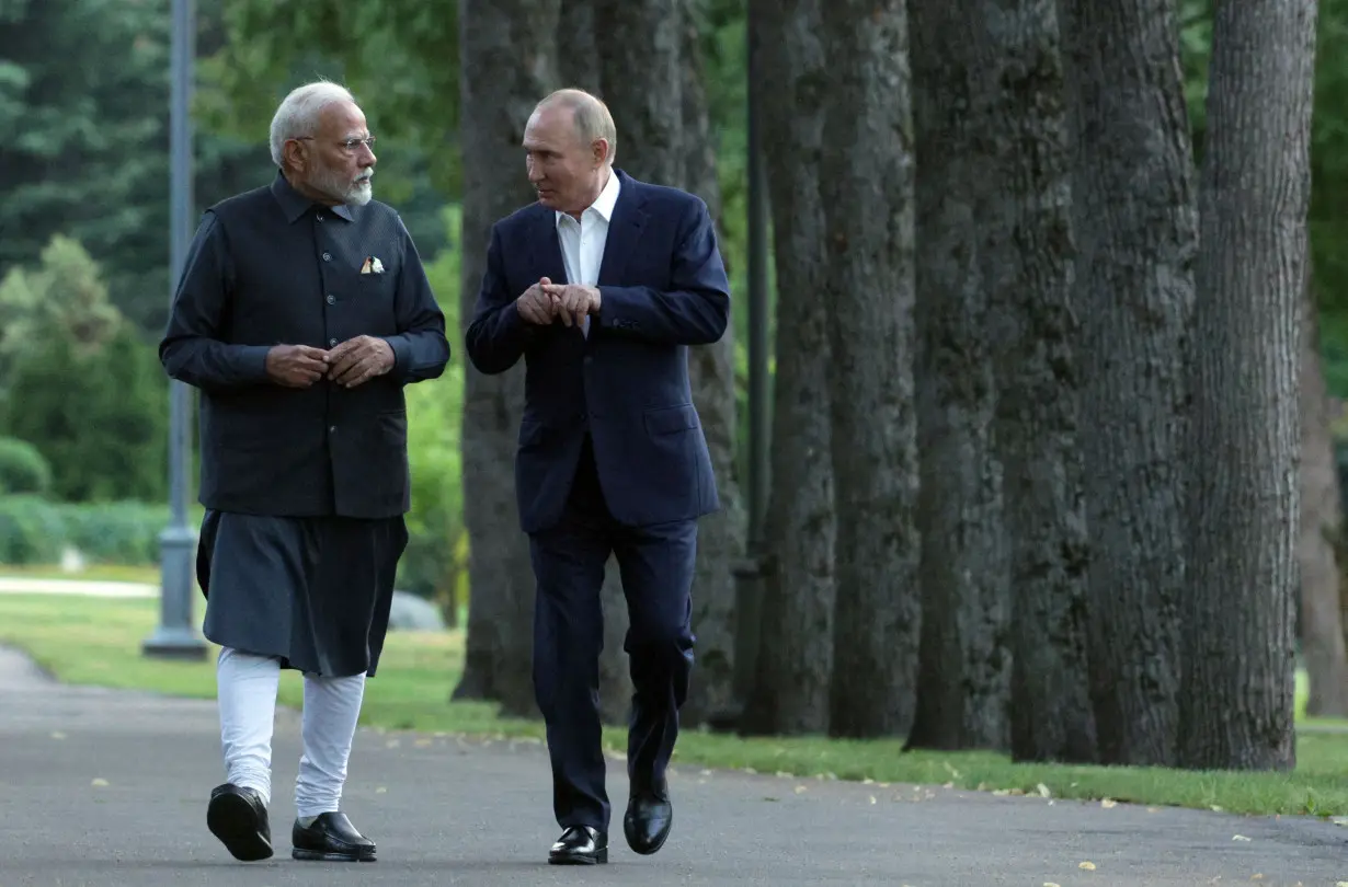 Russia's President Vladimir Putin and Indian Prime Minister Narendra Modi take a walk during an informal meeting near Moscow, on July 8, 2024.