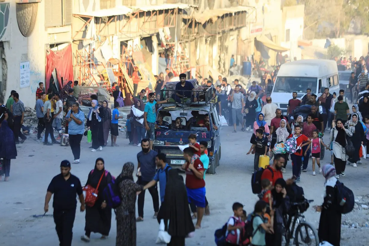 Palestinians flee the eastern part of Gaza City after they were ordered by the Israeli army to evacuate their neighborhoods on July 7.