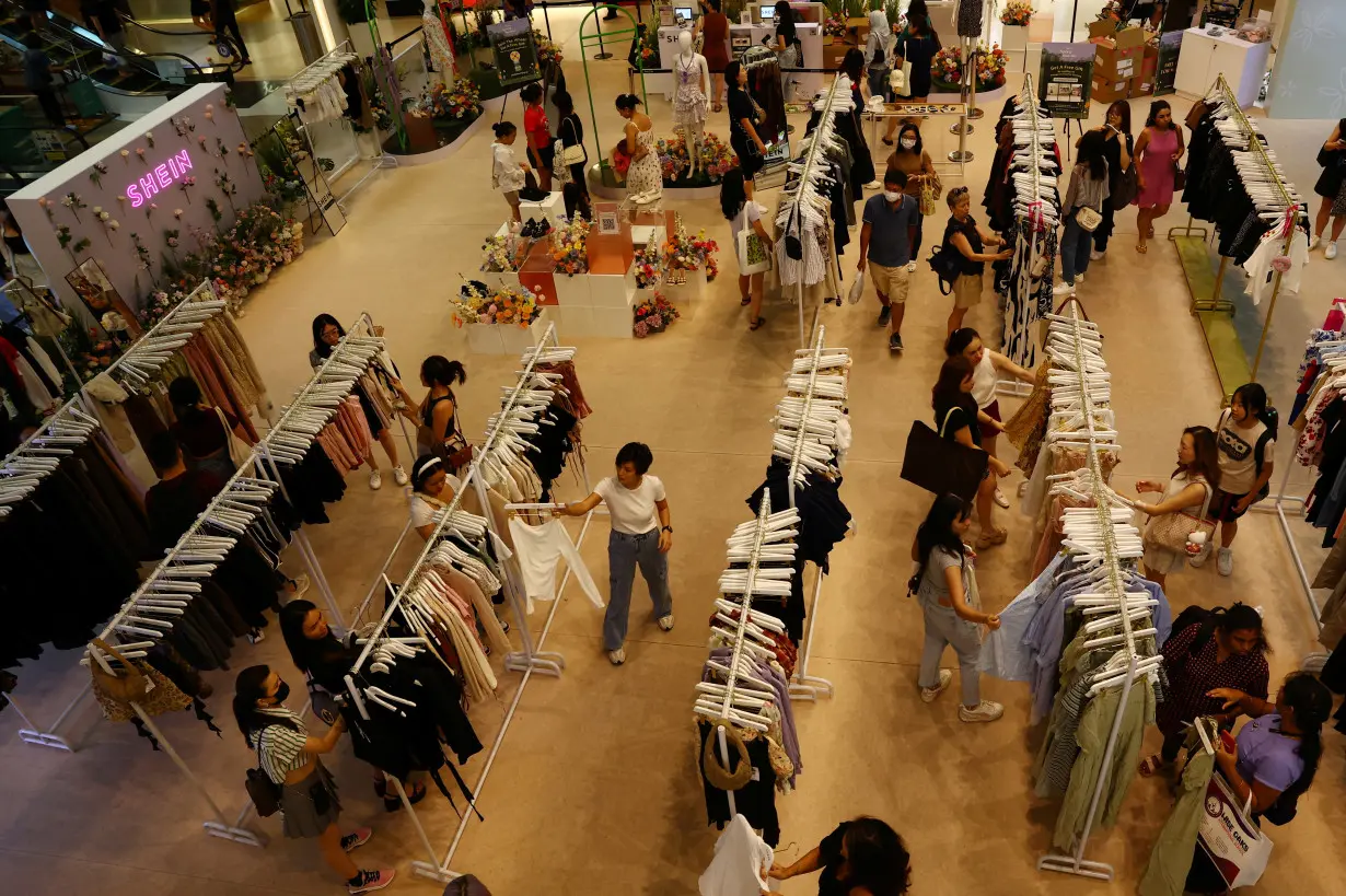 People check out items in a Shein pop-up store at a mall in Singapore