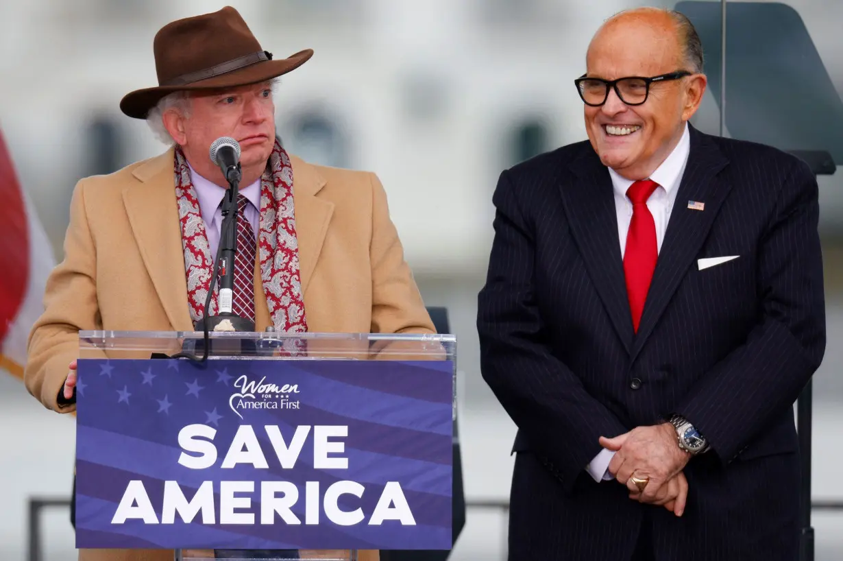 Attorney John Eastman, left, speaks next to Rudy Giuliani as Trump supporters gather ahead of the president's speech to contest the certification by the US Congress of the results of the 2020 presidential election on the Ellipse in January 2021.