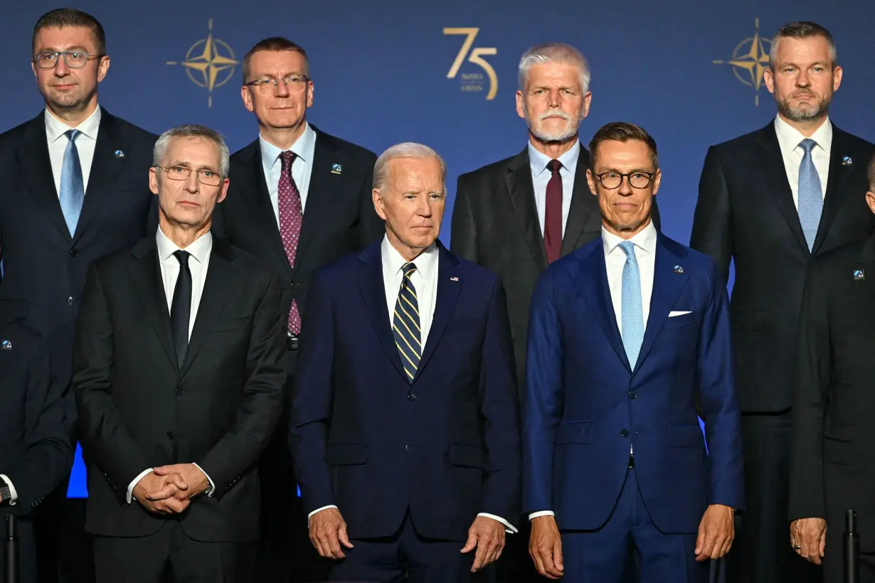 President Joe Biden, flanked by NATO Secretary General Jens Stoltenberg, left, and President of Finland Alexander Stubbs, right, stands with NATO leaders for a group photo during the NATO 75th Anniversary Celebratory Event at the Mellon Auditorium in Washington, DC, on July 9.