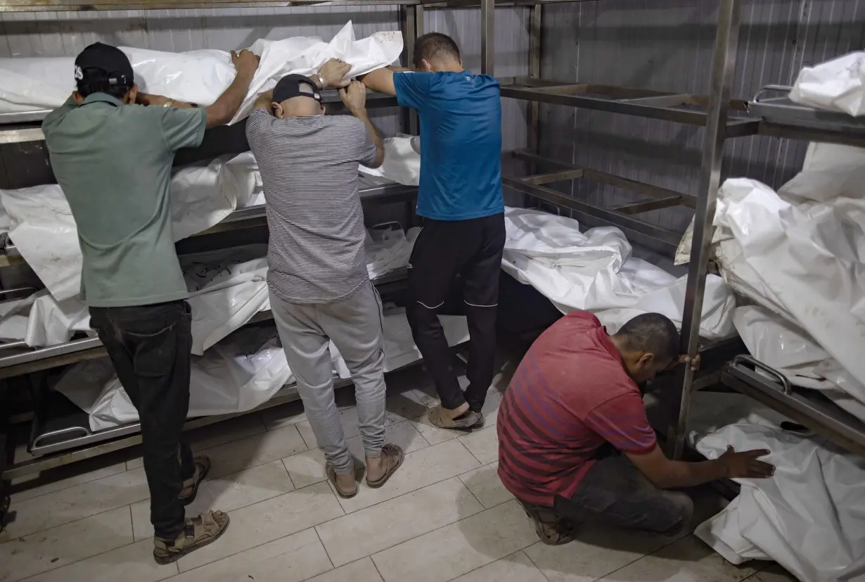 Relatives of killed Palestinians cry next to their bodies inside the morgue at Nasser Hospital in Khan Younis on July 9, 2024.