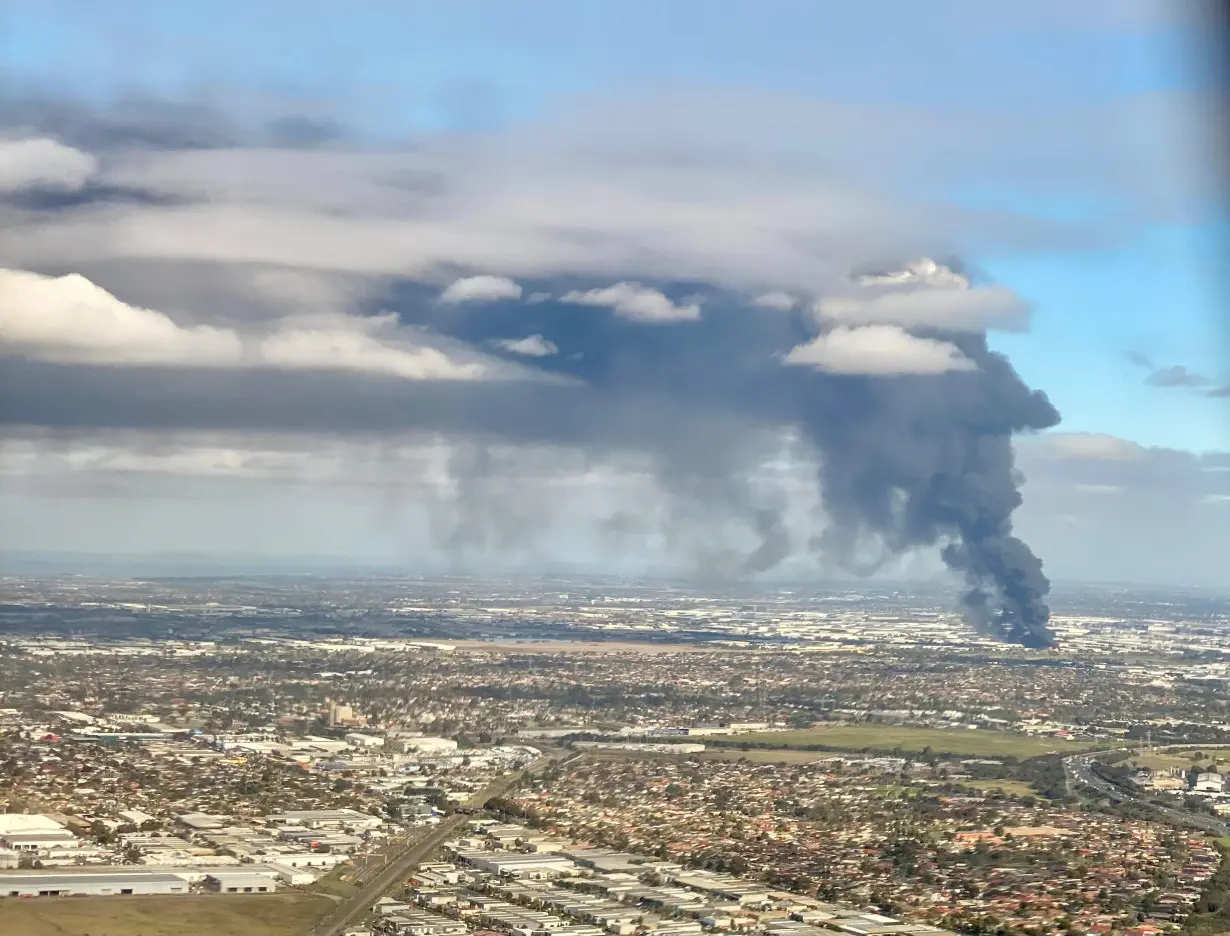 Fire and plumes of smoke rise following an explosion at a factory on the outskirts of Melbourne