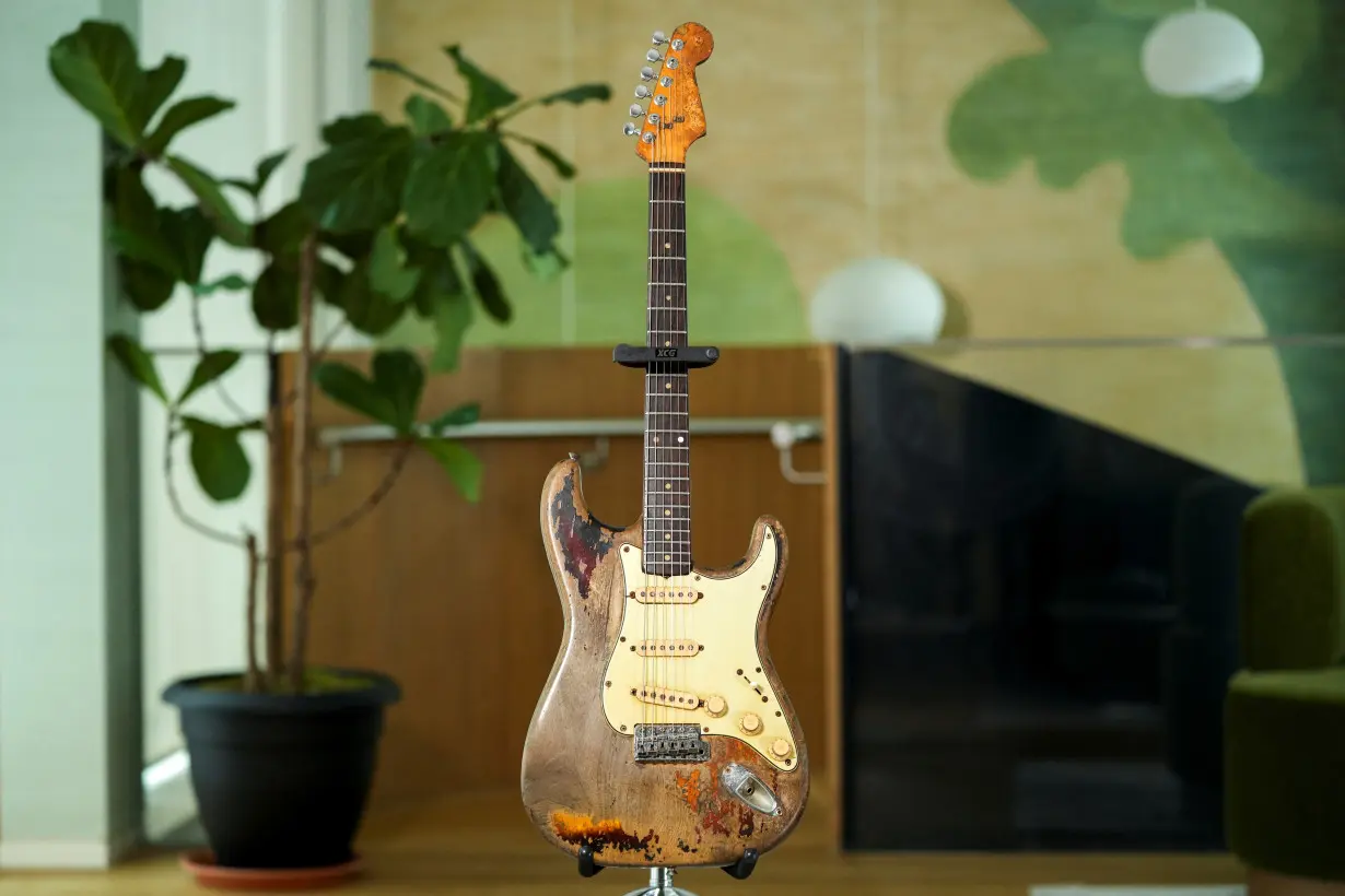 Late Irish musician Rory Gallagher's 1961 Fender Stratocaster is displayed at the Bonhams auction house, in London