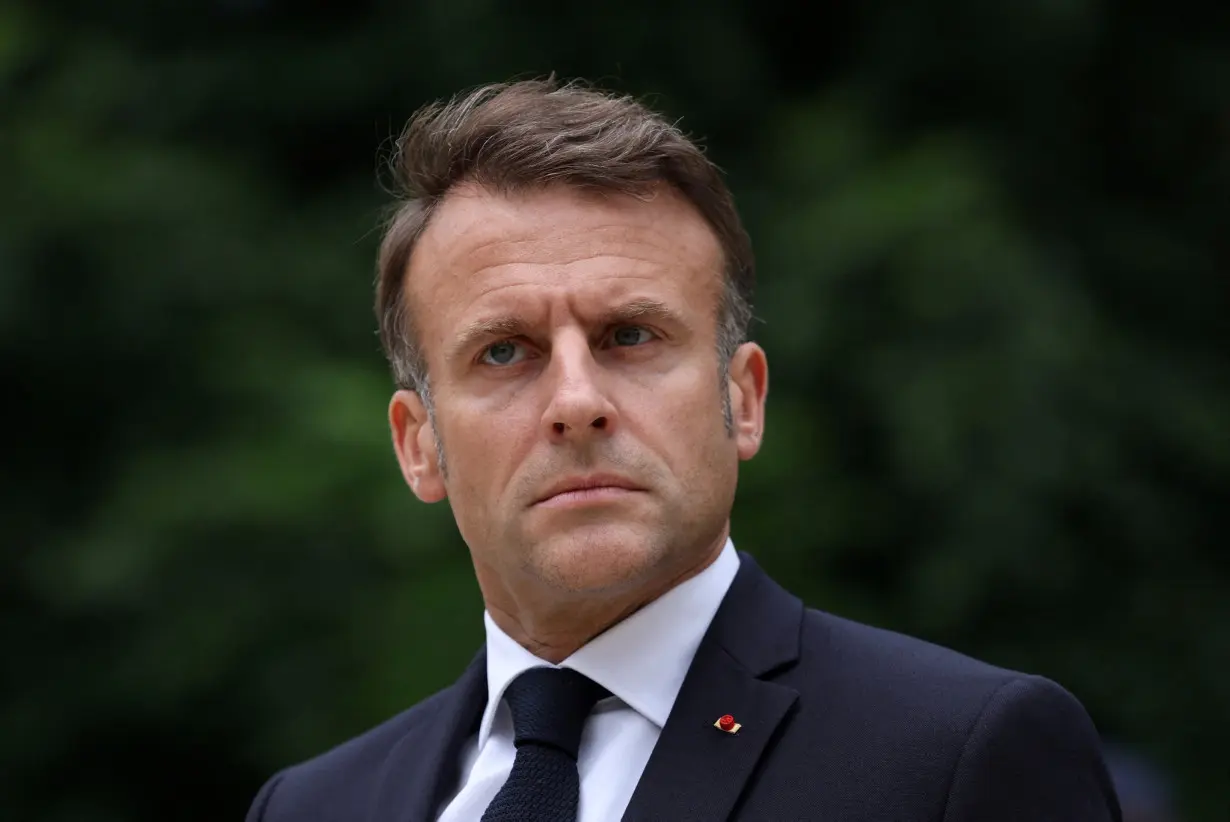 FILE PHOTO: French President Emmanuel Macron reviews troops that will take part in the Bastille Day parade, in Paris