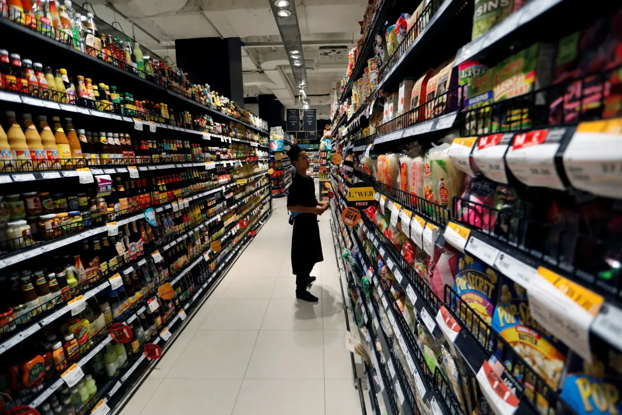 An employee is seen inside the Gourmet Market supermarket in Bangkok