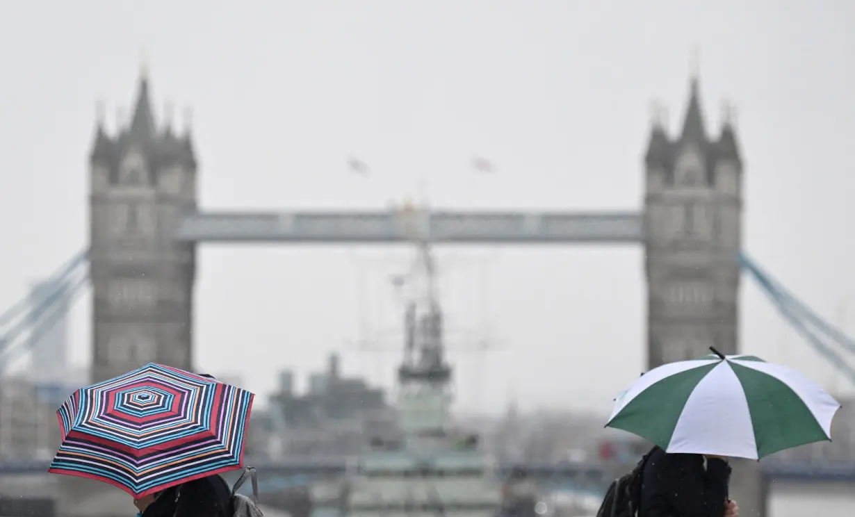 Workers cross London Bridge in London