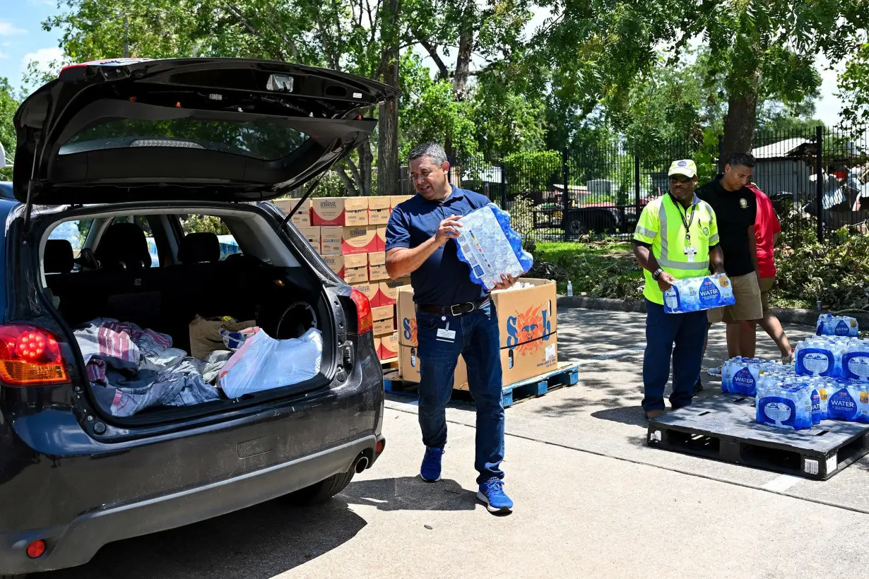 Volunteers hand out water at a distribution station in Houston, Texas, on July 11.