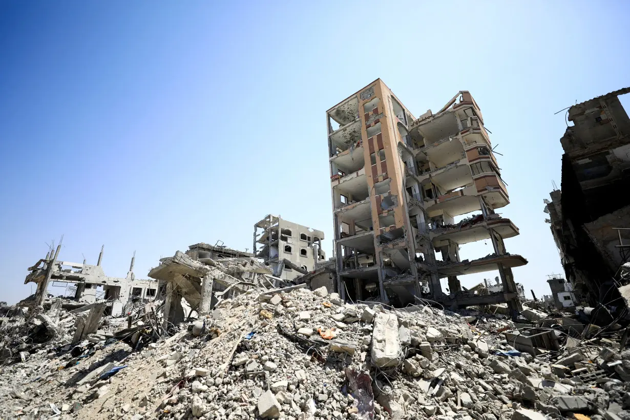 Palestinians inspect damage, after Israeli forces withdrew from Shejaiya neighborhood, in eastern part of Gaza city