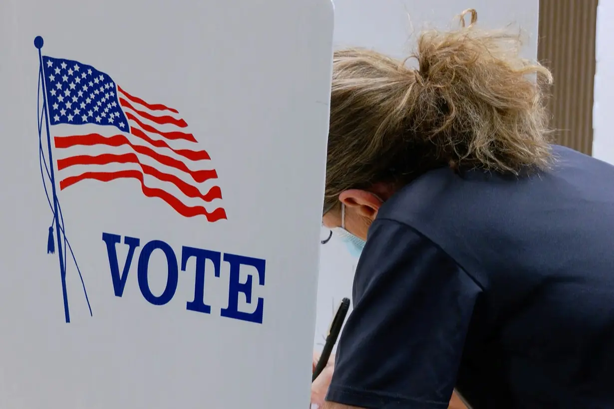 A voter marks a ballot during primary elections at a Wyandotte County polling station