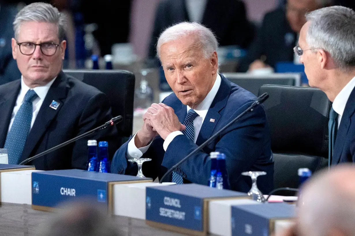 President Joe Biden makes opening remarks during the NATO summit in Washington on Wednesday, July 10, 2024, next to NATO Attorney General Jens Stoltenberg, right, and British Prime Minister Keir Starmer, left.