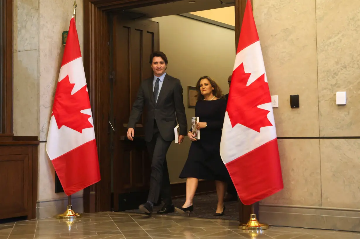 Canada's Prime Minister Justin Trudeau and Finance Minister Chrystia Freeland pose for a picture holding the 2024-25 budget in Ottawa