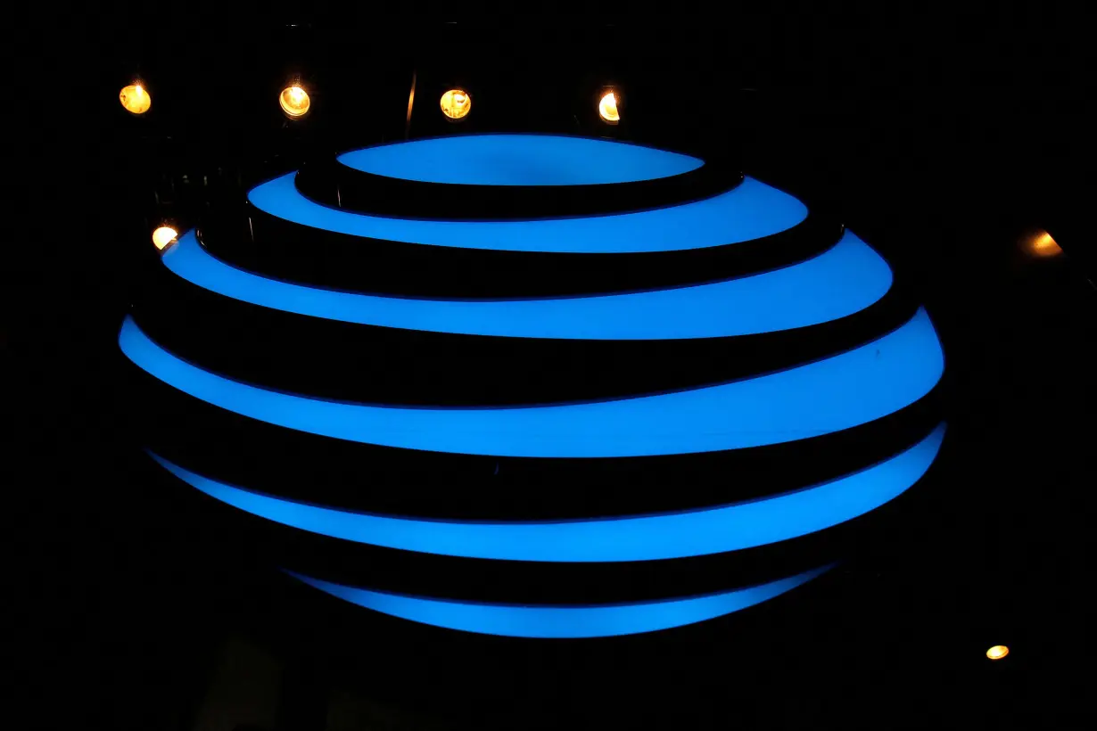 FILE PHOTO: The AT&T logo is seen in a store window in New York