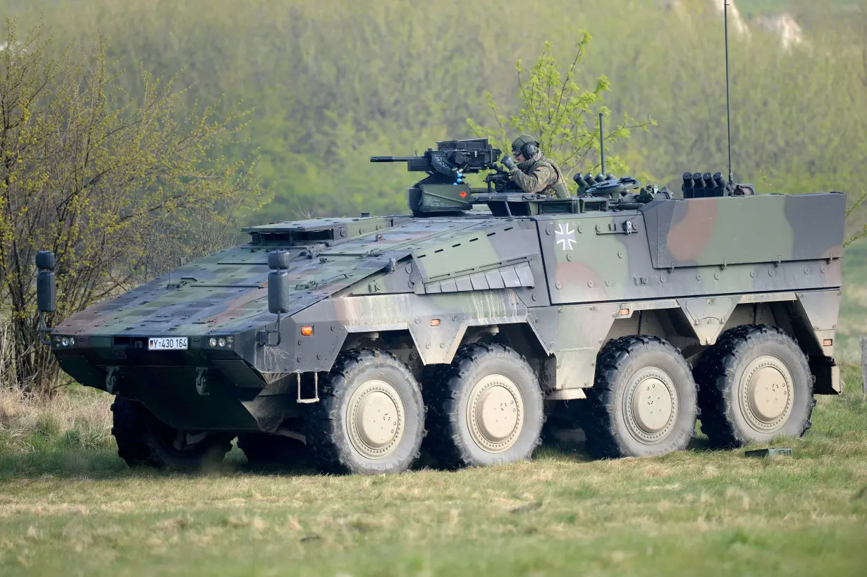 A German soldier reloads a heavy machine gun of an armoured fighting vehicle Boxer during a presentation of German army Bundeswehr in Putlos