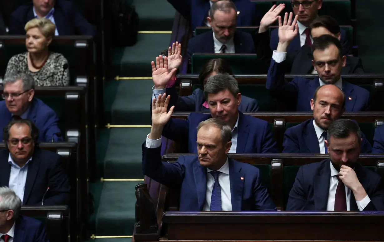 Polish Prime Minister Donald Tusk votes on sending four bills on the liberalisation of abortion laws to be analysed by a special commission, at the parliament in Warsaw