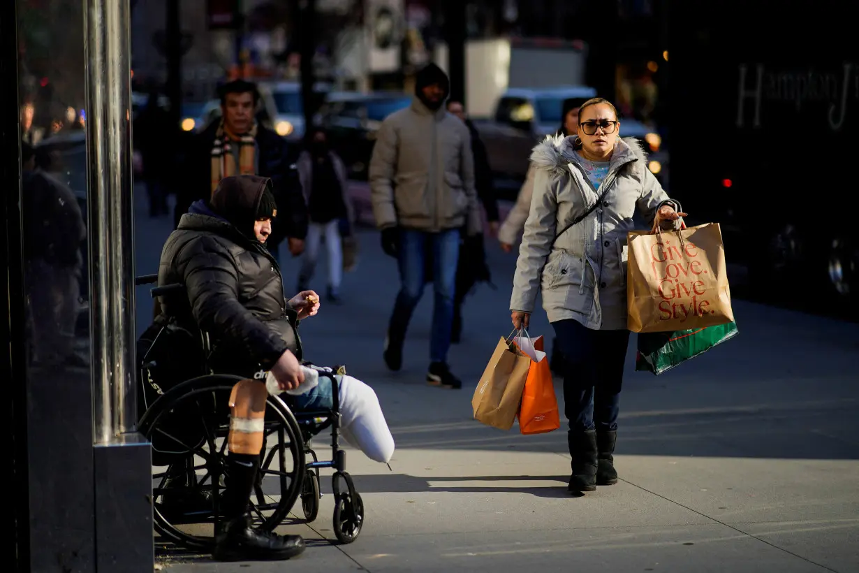 A woman carries shopping bags during the holiday season in New York