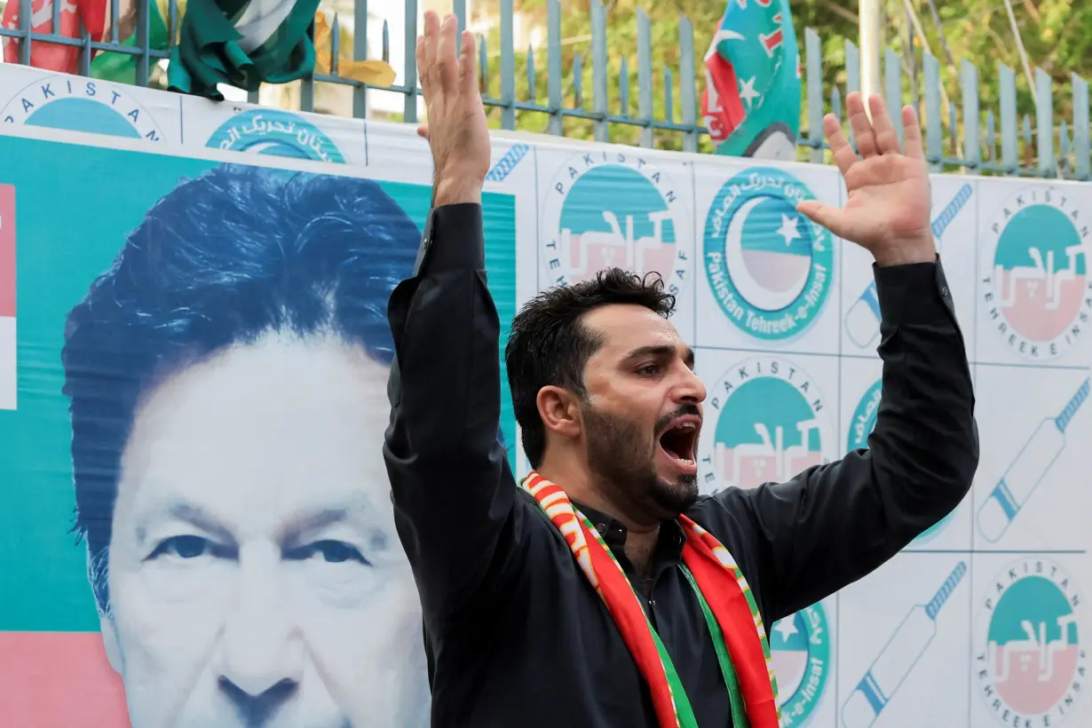 People celebrate after Imran Khan's party wins reserved seats in Pakistan's parliament, in Karachi