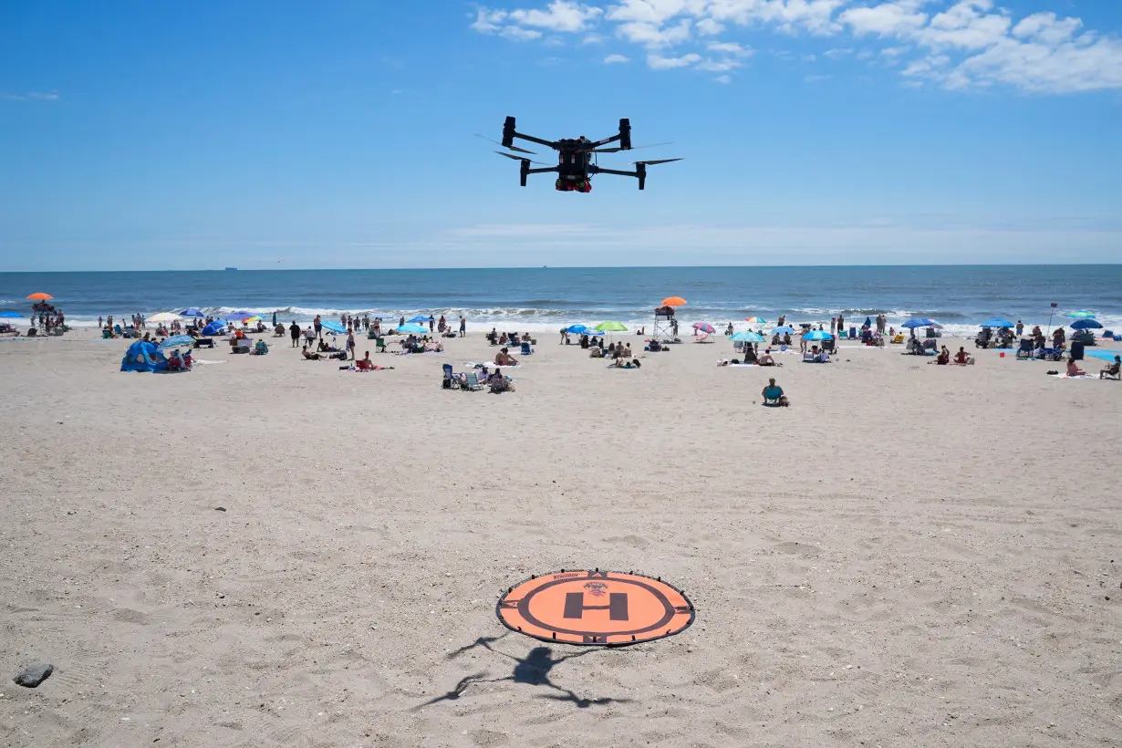 A drone lands for a battery swap at Rockaway Beach in New York, on July 11.