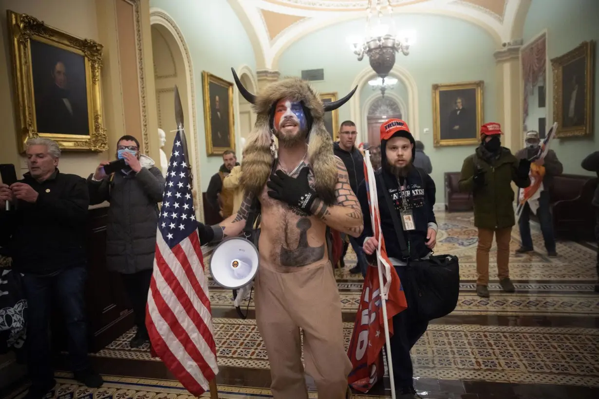 The 'QAnon Shaman' wants his helmet and spear back but the Justice Department objects