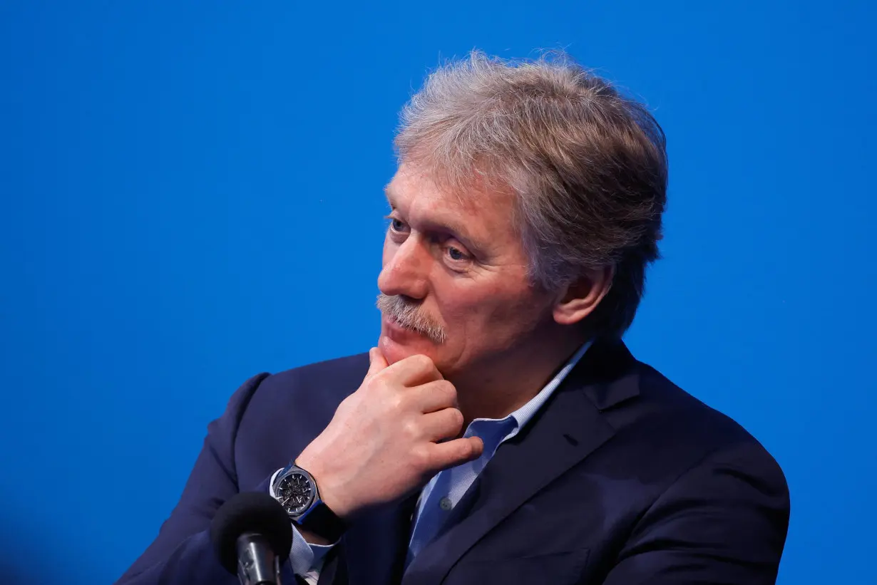 Kremlin spokesman Peskov listens as Russian incumbent President Putin speaks, in Moscow