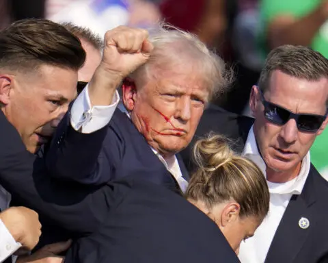 Amid chaos and gunfire, Trump raised his fist and projected a characteristic image of defiance