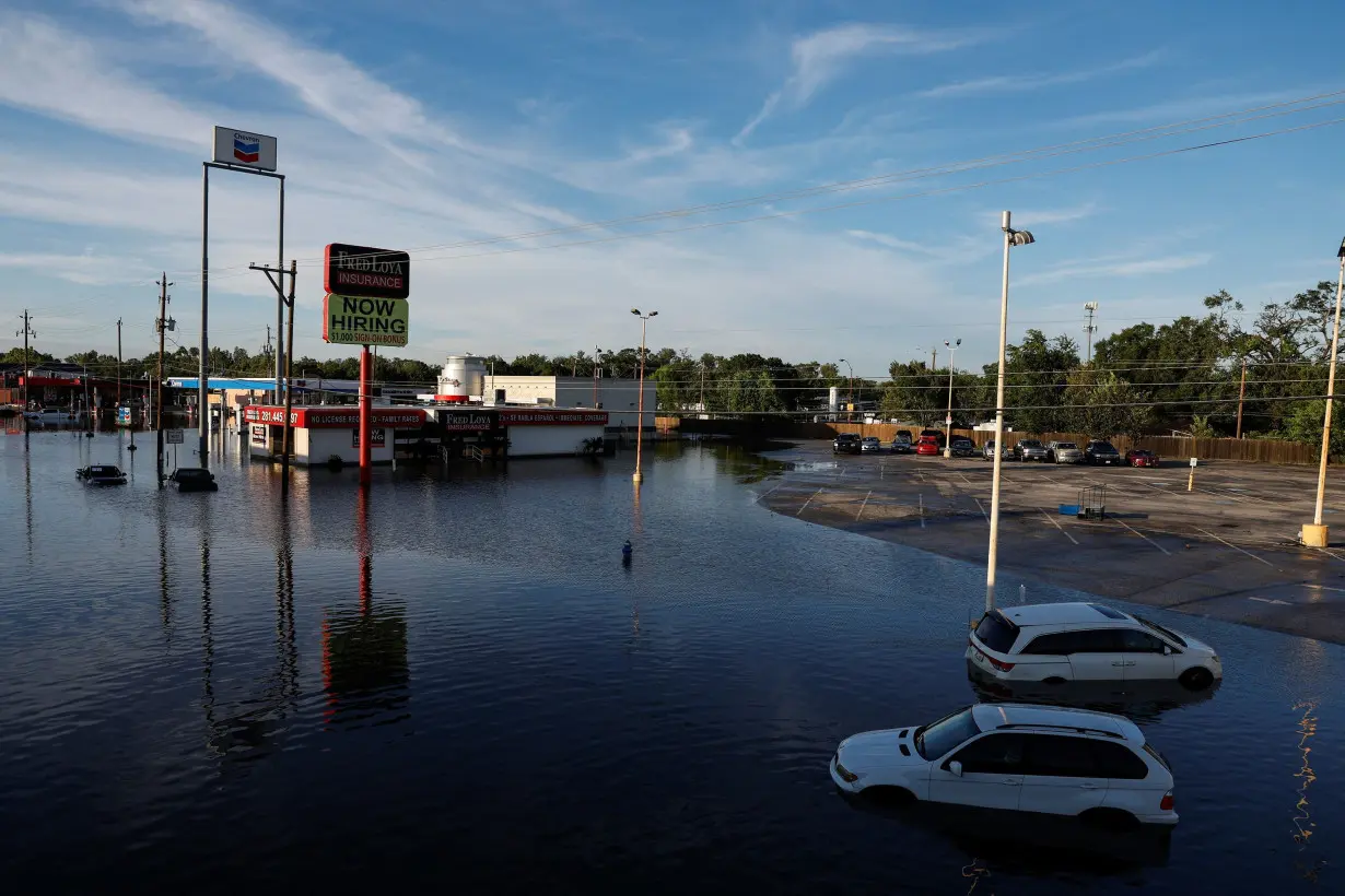 Cars and buildings are partially submerged in floodwaters in the aftermath of Hurricane Beryl in Houston on July 8, 2024. Texas Gov. Greg Abbott threatened to issue an executive order forcing electricity provider CenterPoint Energy to improve its level of storm preparedness.