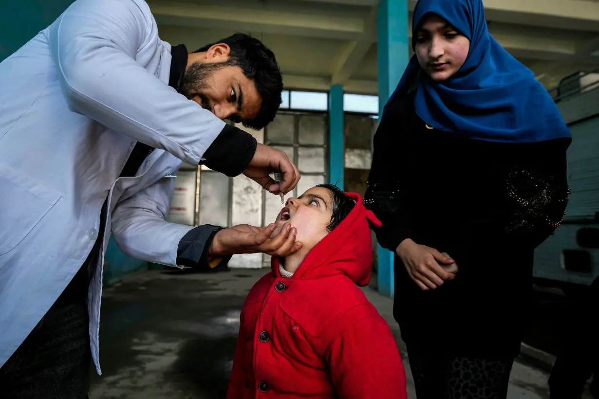 A government health worker administers polio drops to a child in Srinagar, Indian-controlled Kashmir, on March 3.