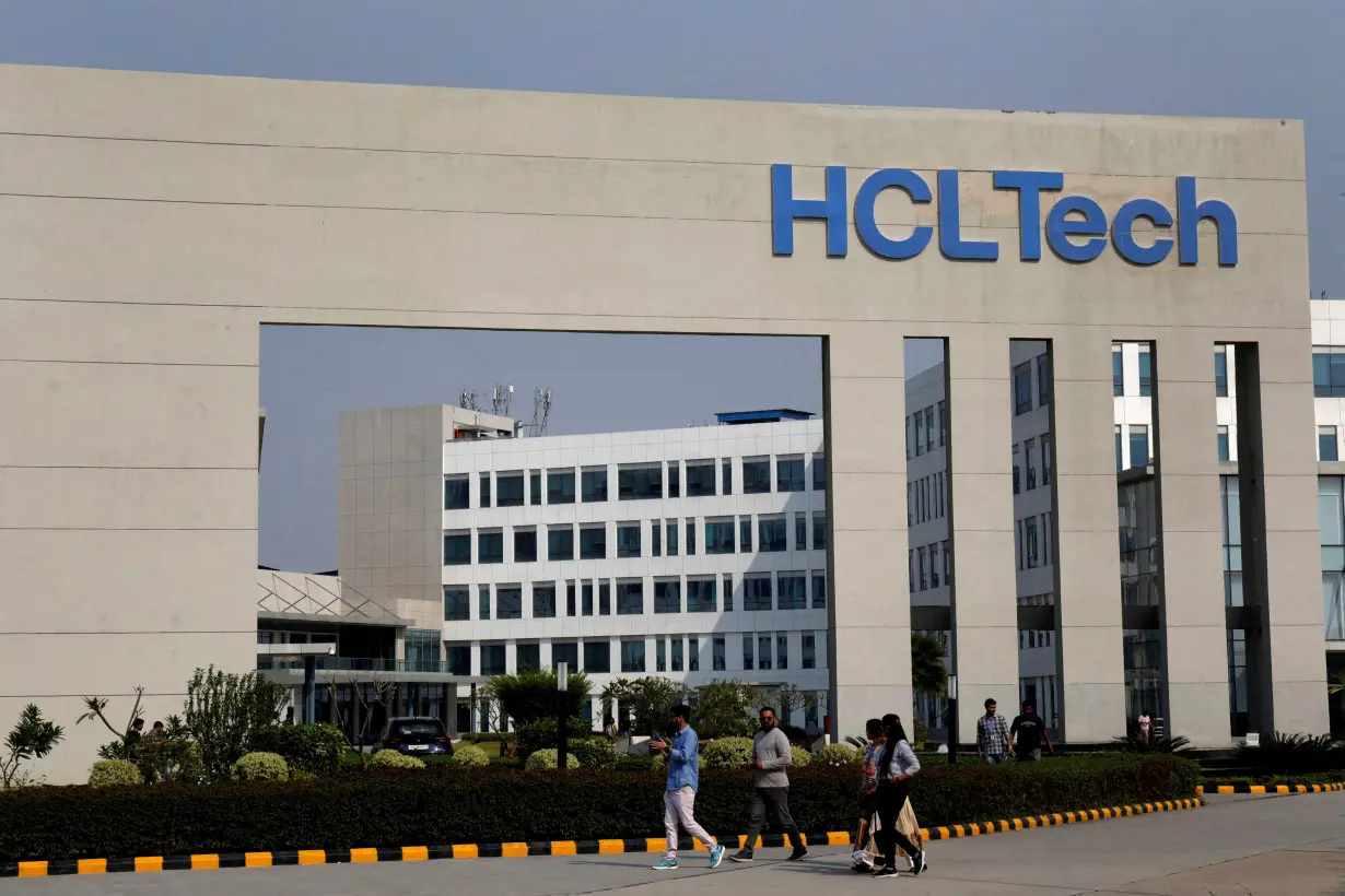 FILE PHOTO: FILE PHOTO: Employees of HCLTech walk inside the office premises on outskirts of Lucknow