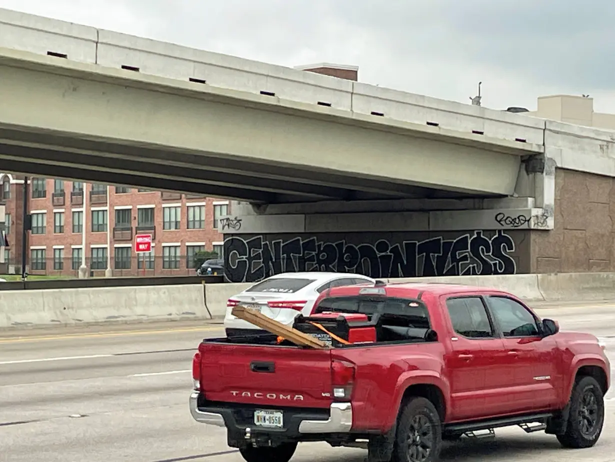 A graffiti on an underpass of I-10 highway in central Houston refers to power provider CenterPoint Energy, in Houston