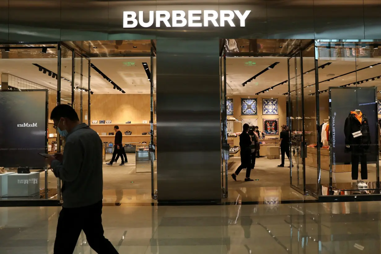 FILE PHOTO: Man walks past a Burberry store in Beijing