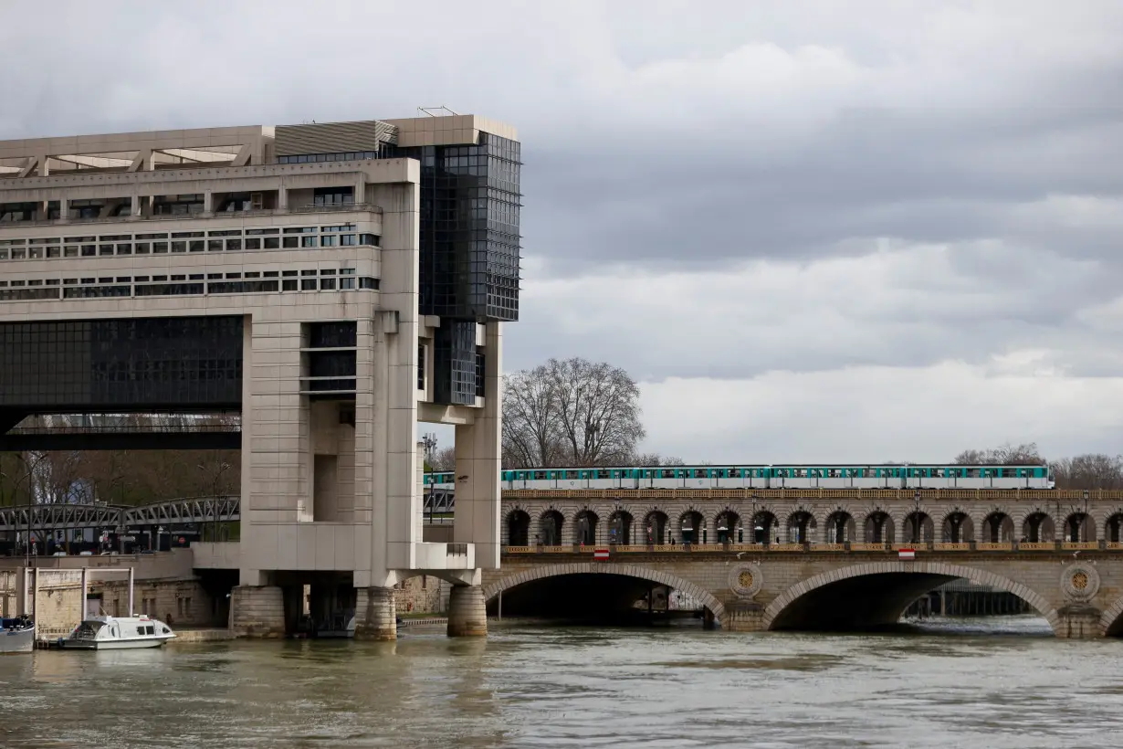 A metro passes by the Bercy Economy and Finance Ministry in Paris