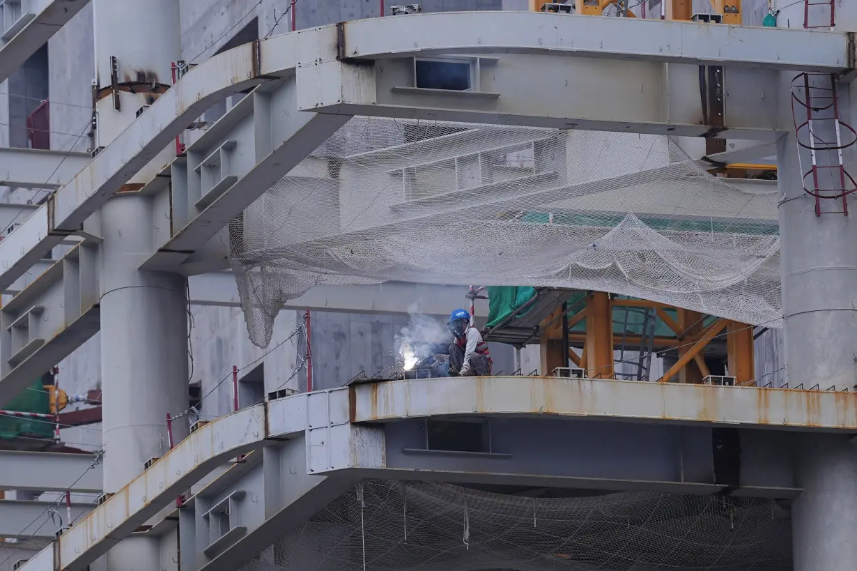 Worker works on a building under construction in Beijing's Central Business District (CBD)