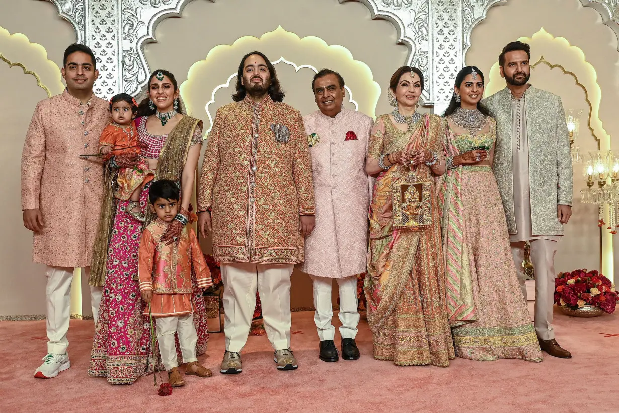 The Ambani family poses for photos as they arrive at Friday's wedding ceremony in Mumbai.