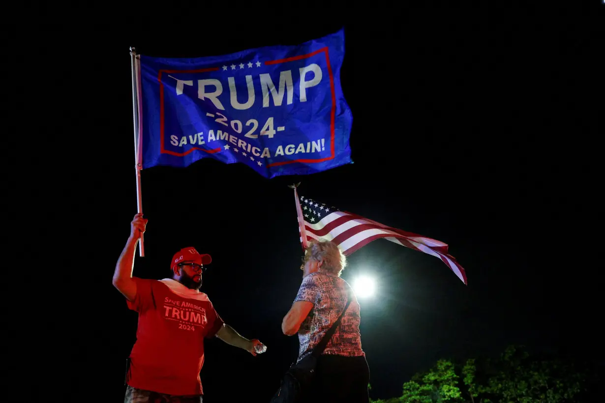 People gather after Republican presidential candidate and former U.S. President Donald Trump was injured when shots were fired, in Palm Beach