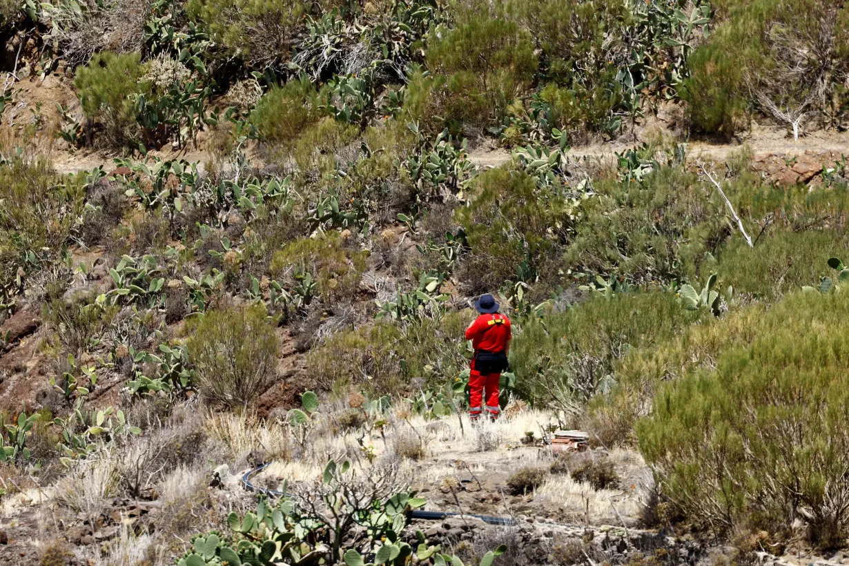 FILE PHOTO: A volunteer firefighter searches for the young Briton Jay Slater in the Juan Lopez ravine near Masca