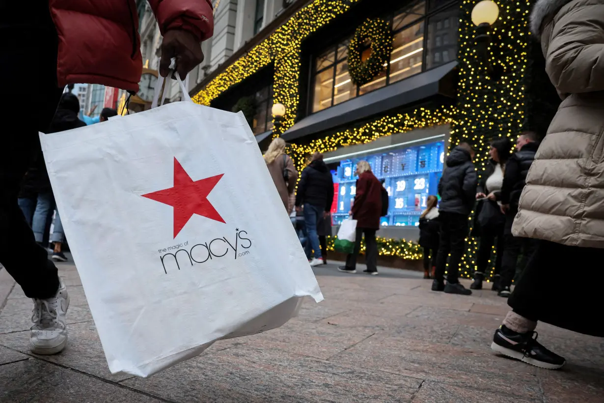 FILE PHOTO: A customer exits the Macy's flagship department store in midtown Manhattan in New York