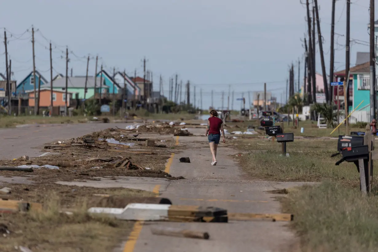 FILE PHOTO: Resident walks past debris in the aftermath of Hurricane Beryl in Surfside Beach, Texas