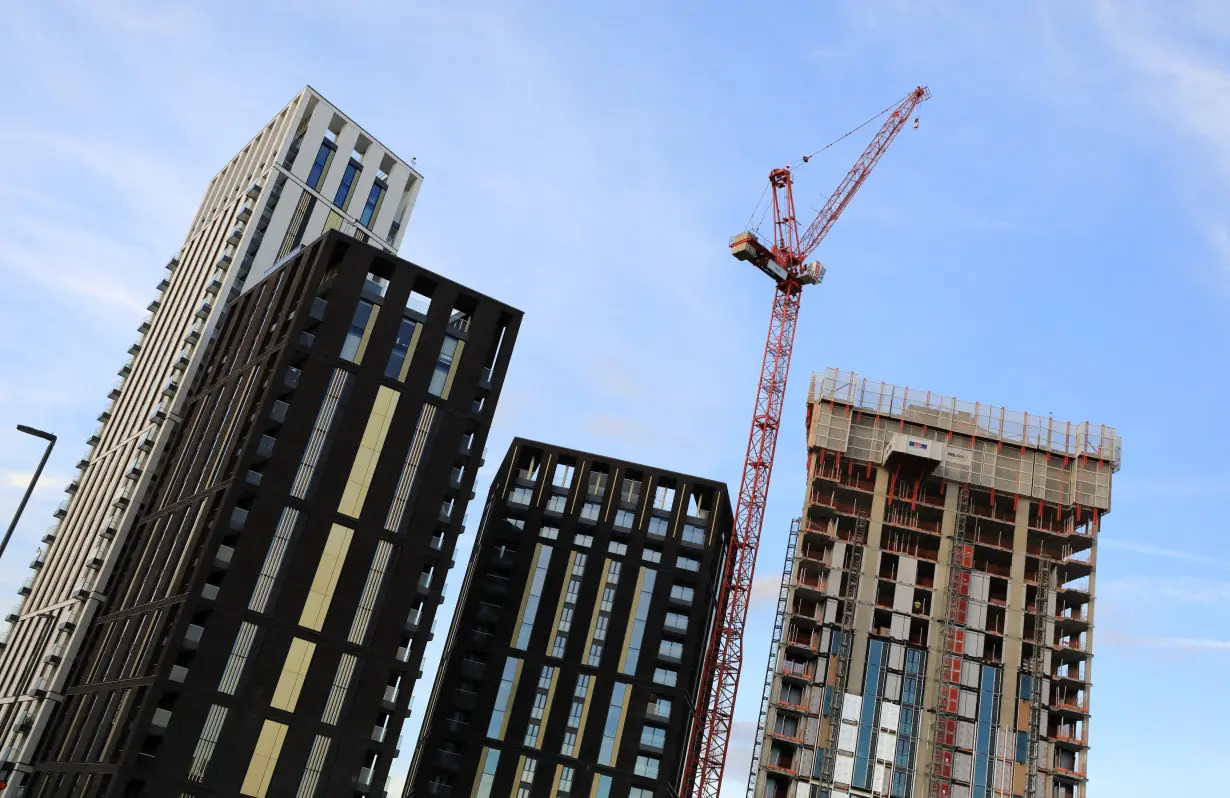 FILE PHOTO: A crane is seen above some high rise building construction works at Lewisham, in London