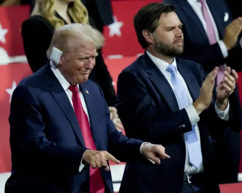 Donald Trump enters Republican convention hall with a bandaged ear and gets a hero's welcome