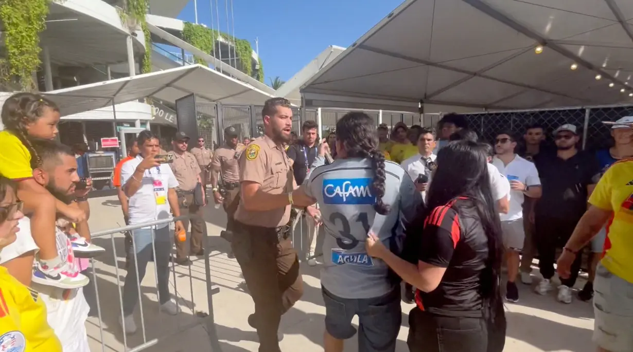 FILE PHOTO: People get into a scuffle with the police at Hard Rock Stadium, in Miami