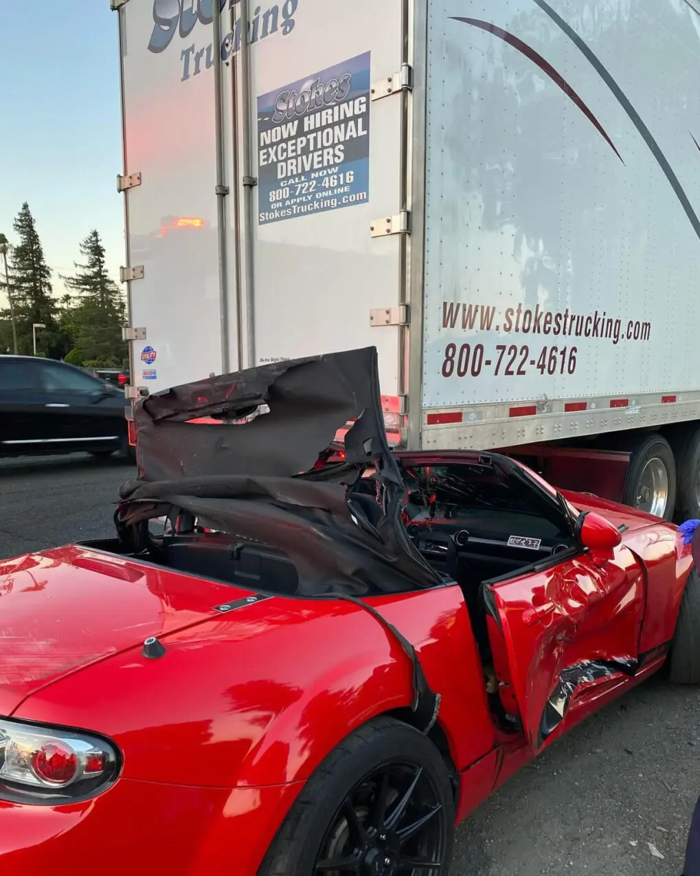 Driver escapes with minor injuries after crashing under big rig