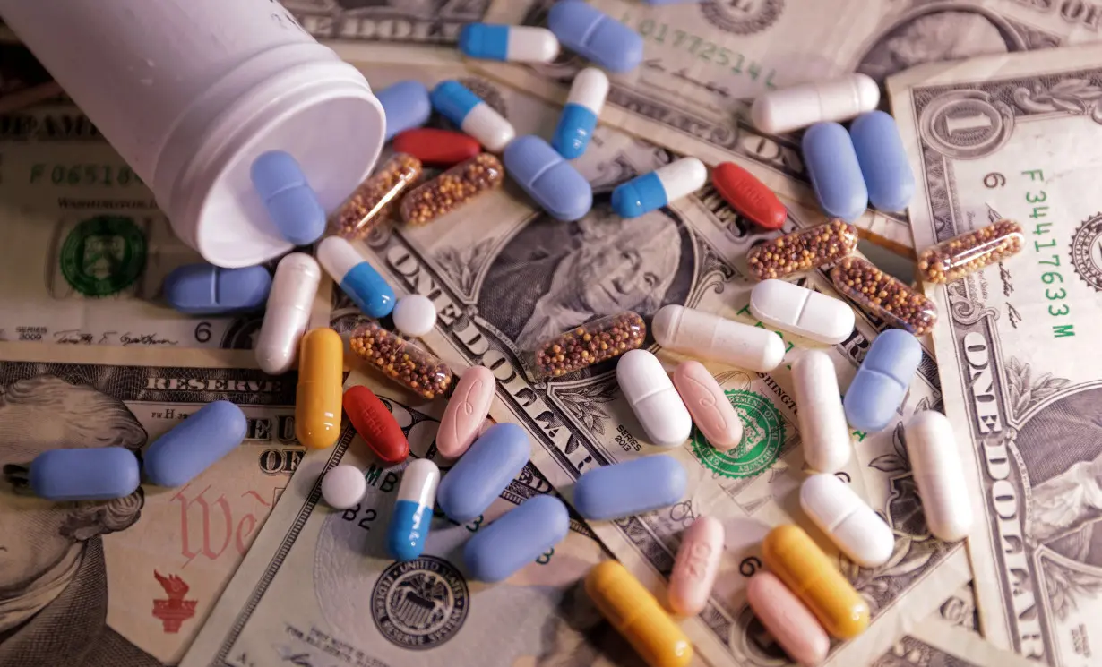 Illustration shows U.S. dollar banknotes and medicines