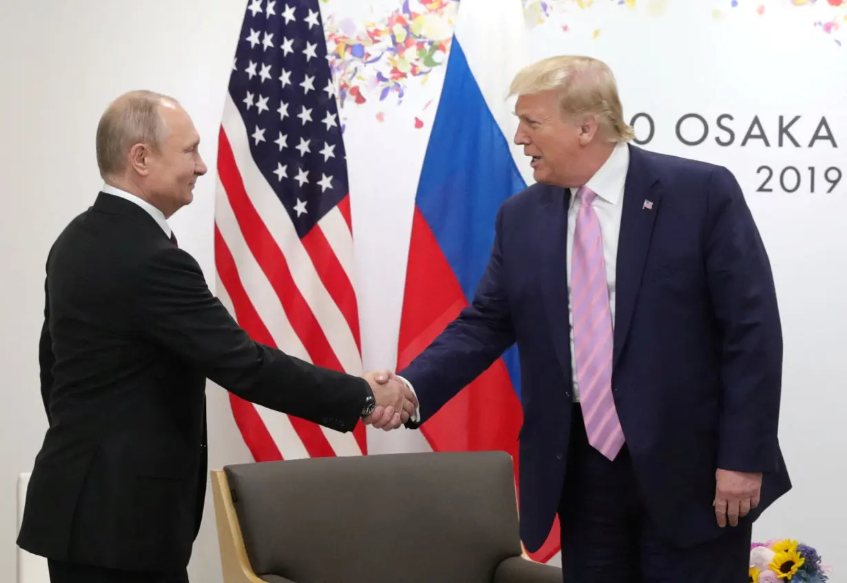 FILE PHOTO: Russia's President Vladimir Putin and U.S. President Donald Trump attend a meeting on the sidelines of the G20 summit in Osaka