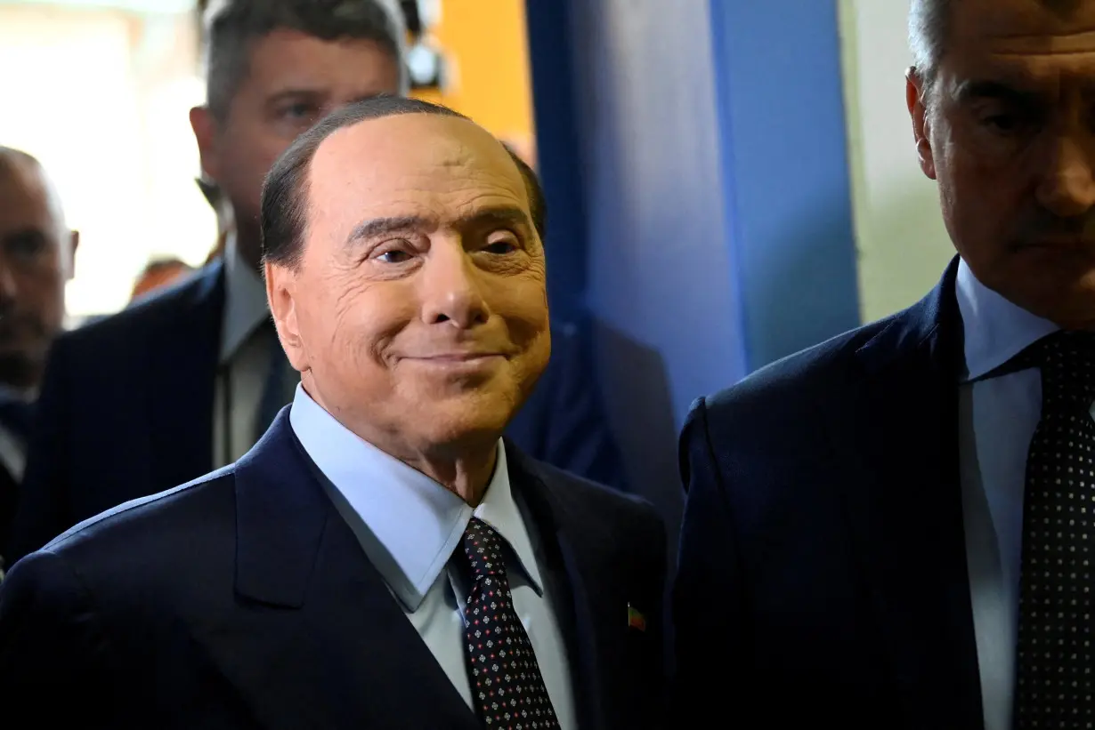 FILE PHOTO: Silvio Berlusconi walks at a polling station in Milan, Italy, September 25, 2022.