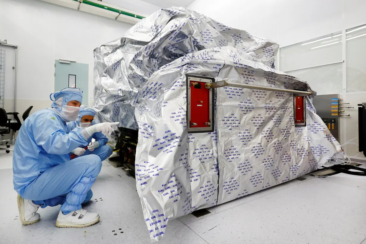 Assembly engineers work on a TWINSCAN DUV lithography system at ASML in Veldhoven