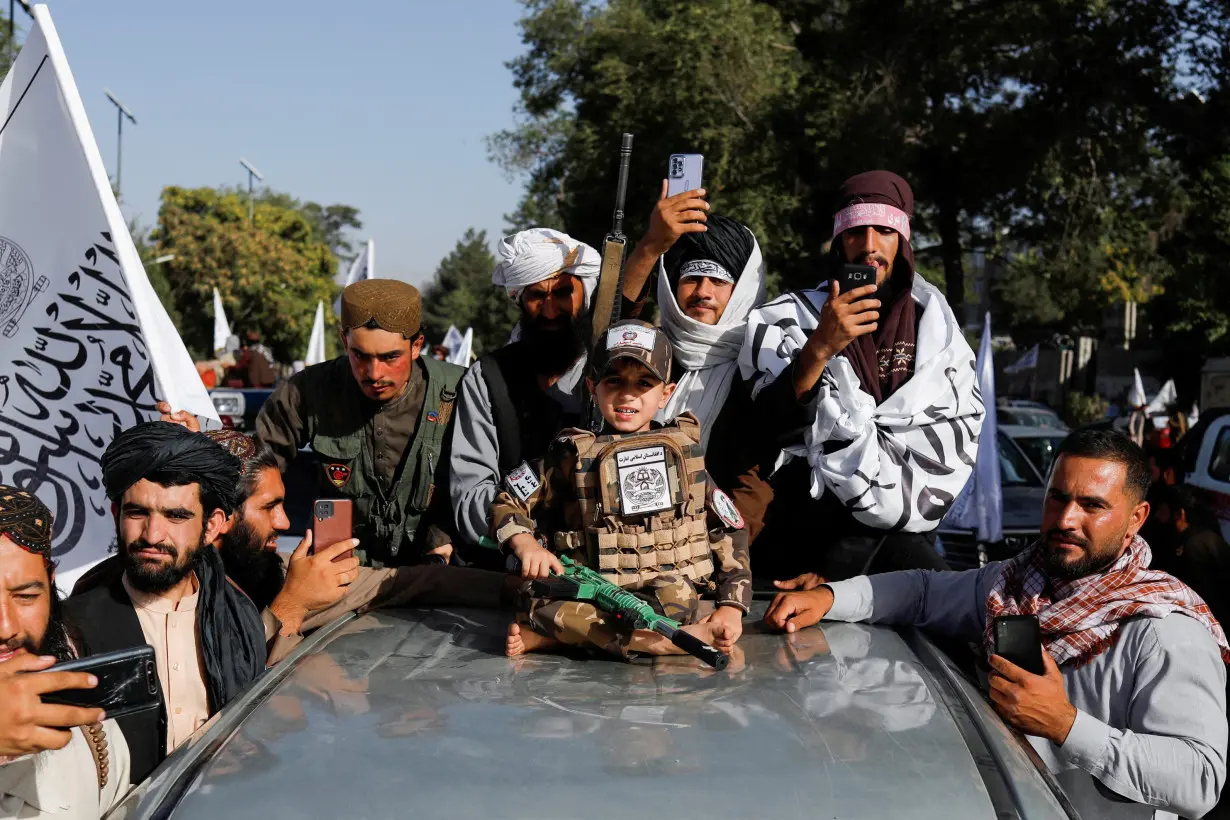 FILE PHOTO: Taliban supporters celebrate on the second anniversary of the fall of Kabul at a street near the U.S. embassy in Kabul