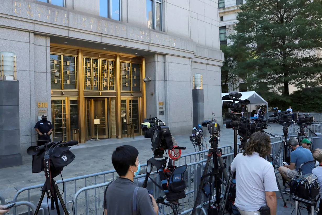 FILE PHOTO: Members of the media gather outside the United States District Court for the Southern District of New York in Manhattan