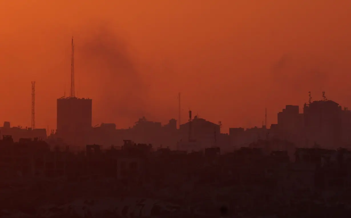 Smoke rises from Gaza during sunset, amid the Israel-Hamas conflict, near the Israel-Gaza border