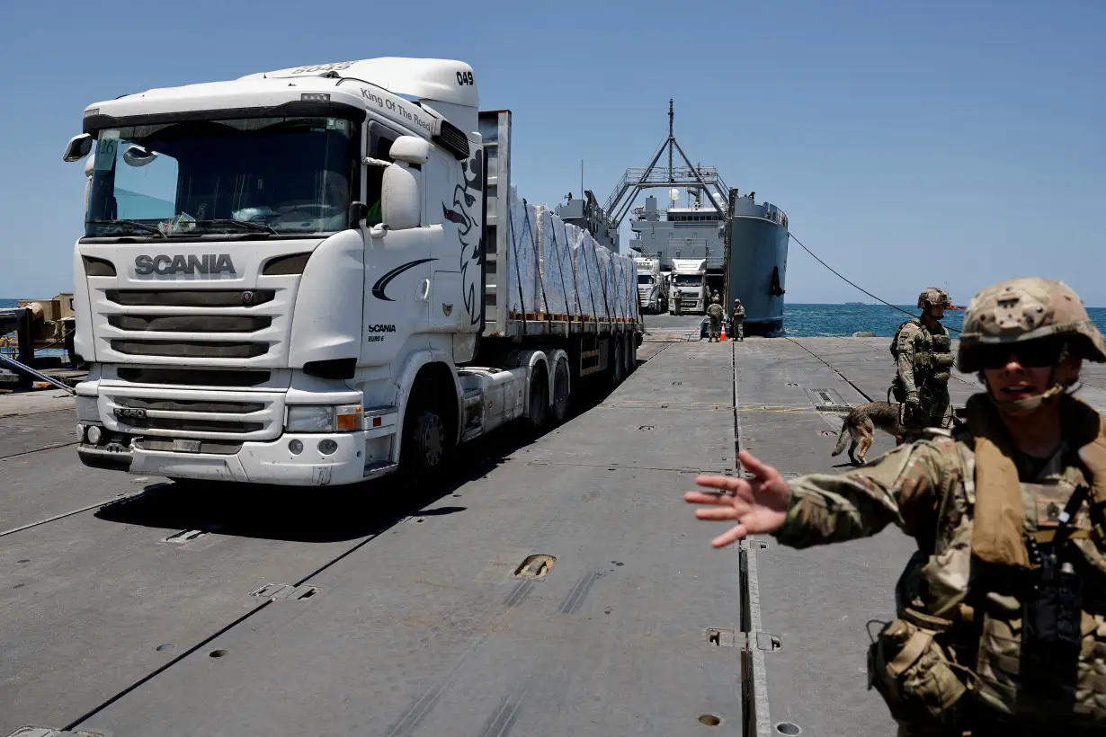 FILE PHOTO: Trucks carry humanitarian aid across Trident Pier