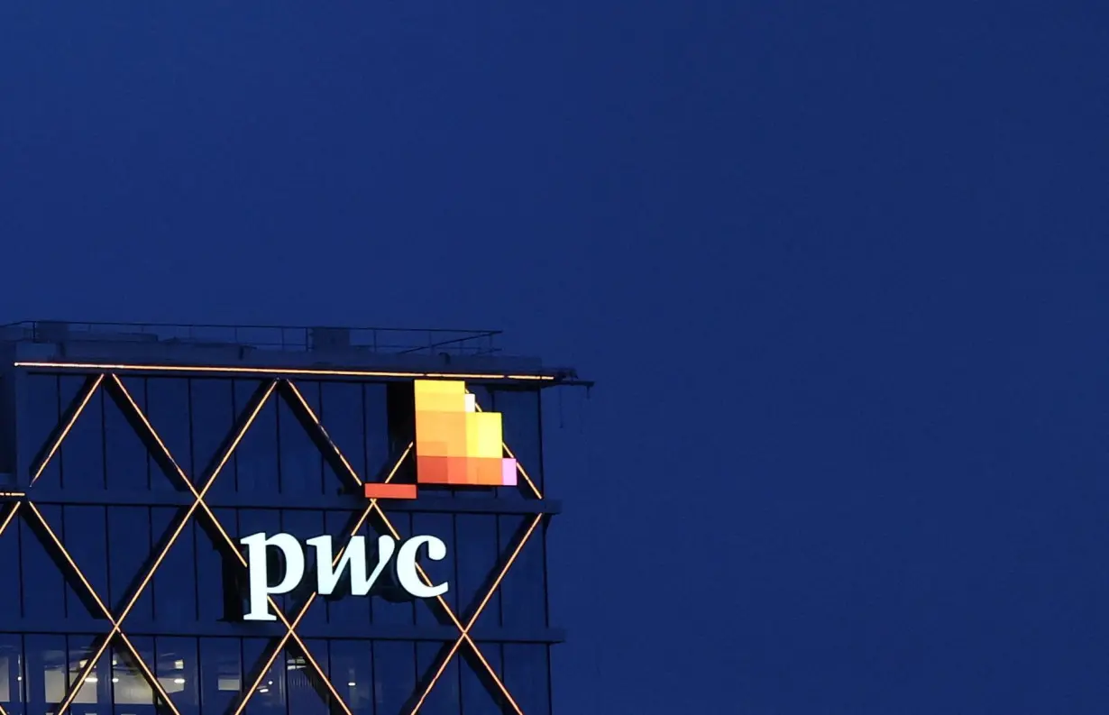 The logo of accounting firm PricewaterhouseCoopers (PwC) is seen on the top of a Brussels' office of the company in Diegem